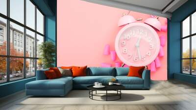 Restful sleeping, wear ear plugs and how to hear the alarm clock without missing sleep due to noise concept theme with earplugs and vintage clock isolated on pink background with copy space Wall mural